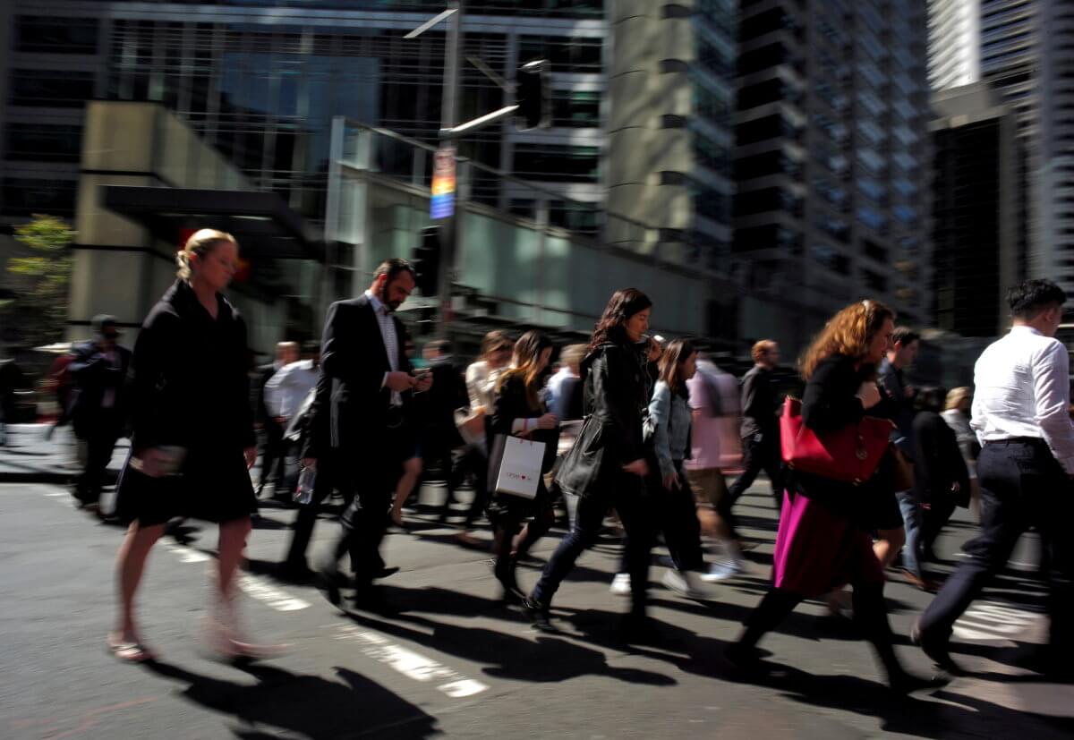 FILE PHOTO: Office workers and shoppers walk through Sydney’s central business district in Australia