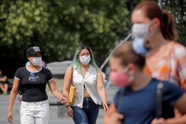 FILE PHOTO: People wear masks, as cases of the infectious Delta variant of COVID-19 continue to rise, in Washington Square Park in New York