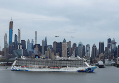 A cruise liner sails past the skyline of New York City,New York