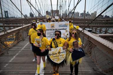 People walk across the Brooklyn Bridge together for those who were lost due to coronavirus disease (COVID-19) in New York