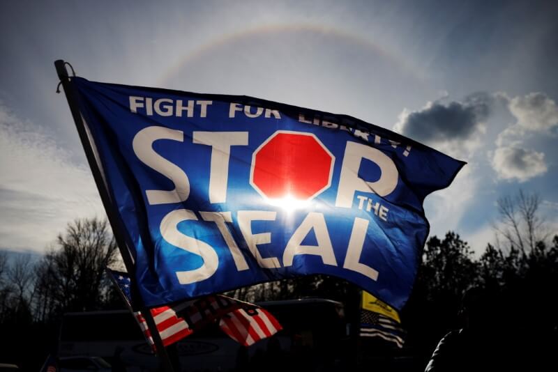 A “Stop the Steal” flag flies outside a campaign rally with President Trump in Dalton