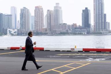 New York Governor Andrew Cuomo walks to his helicopter after announcing his resignation in Manhattan, New York City