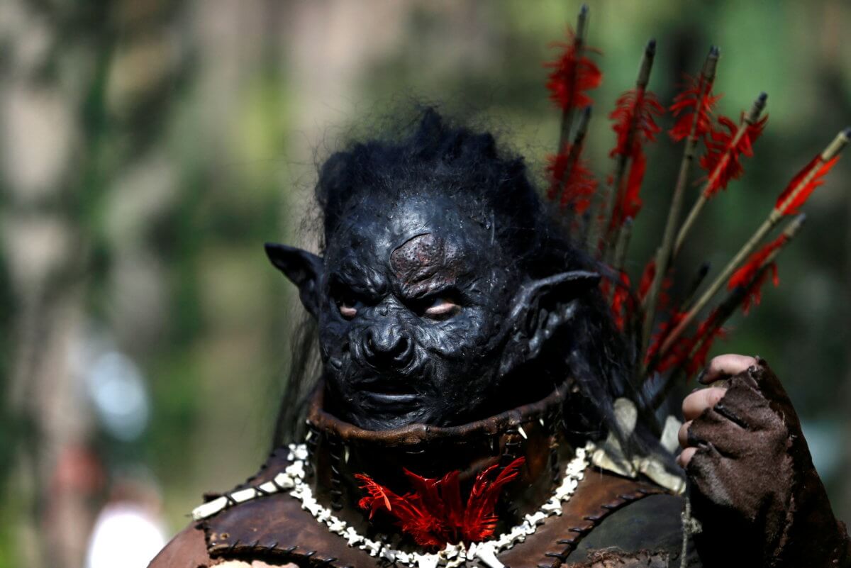 FILE PHOTO: A participant dressed as a character from J.R.R. Tolkien’s novel “The Hobbit” takes part in a reenactment of the “Battle of Five Armies” in a forest near Doksy