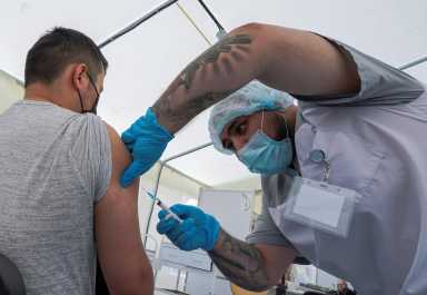 FILE PHOTO: Migrant workers receive the one-dose Sputnik Light vaccine against the coronavirus disease in Moscow