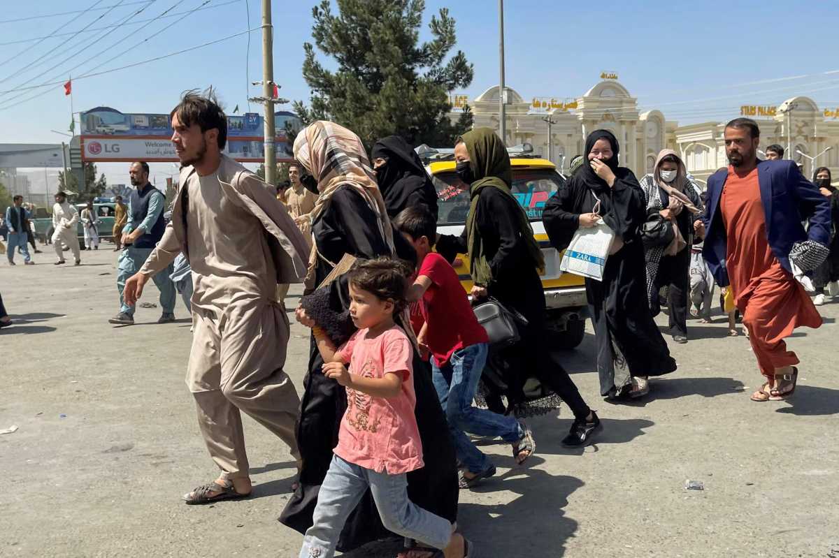 People try to get into Hamid Karzai International Airport in Kabul