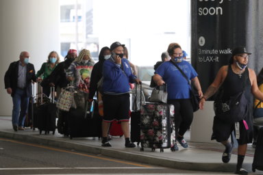 FILE PHOTO: Passengers queue at LAX airport before Memorial Day weekend in Los Angeles