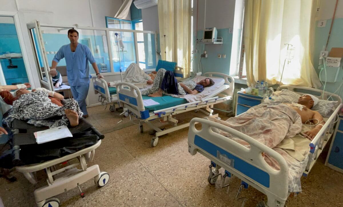 Wounded Afghan men receive treatment at a hospital after yesterday’s explosions outside airport in Kabul