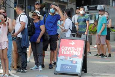 People line up at a coronavirus disease (COVID-19) testing at a mobile testing van in New York
