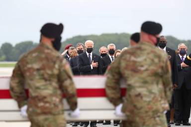 U.S. President Joe Biden salutes during the dignified transfer of the remains of U.S. Military service members who were killed by a suicide bombing at the Hamid Karazi International Airport