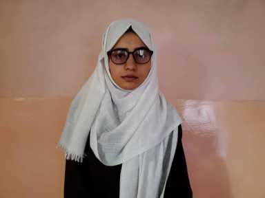 Salgy poses for a photo after topping Afghanistan’s university entrance exams, in Kabul