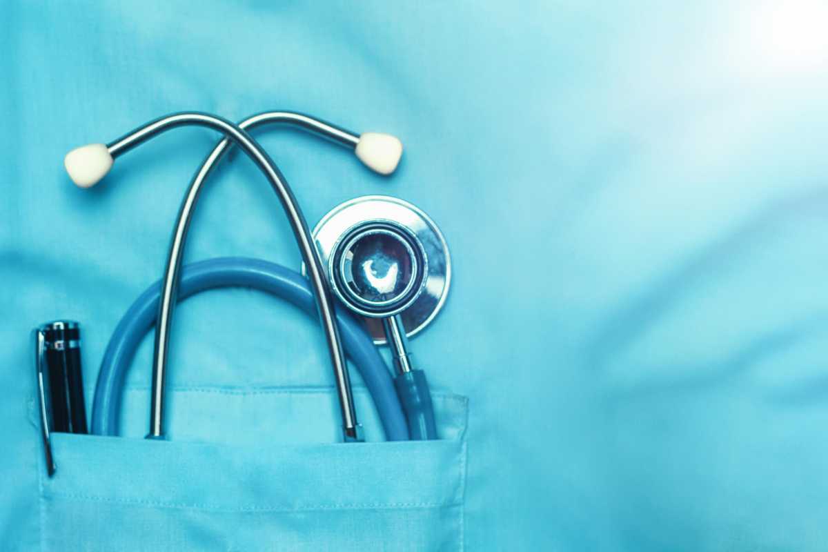 Concept Global Healthcare, Medicine And Insurance. Stethoscope and pen in doctor robe pocket