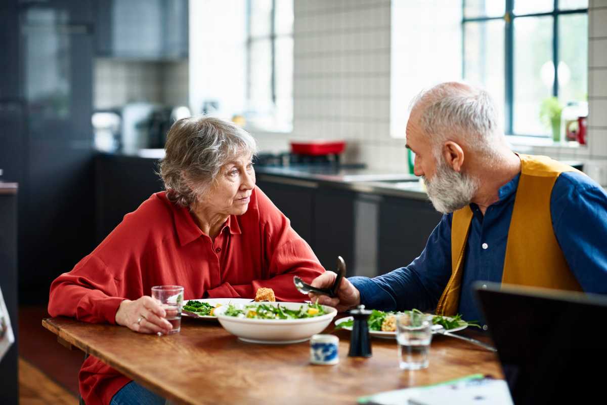 Senior couple having serious discussion over lunch at home