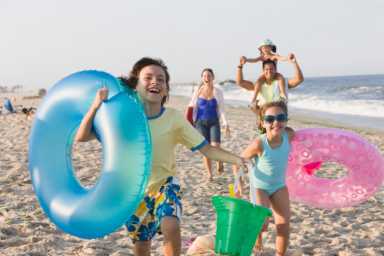 Hispanic family enjoying beach together