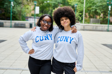 Two students wear CUNY sweatshirts