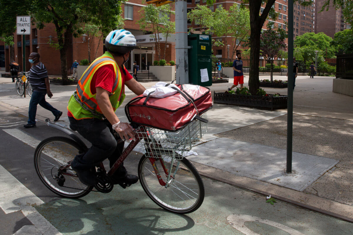 A delivery worker cycles throuugh Kips Bay in Manhattan, June 4, 2020.