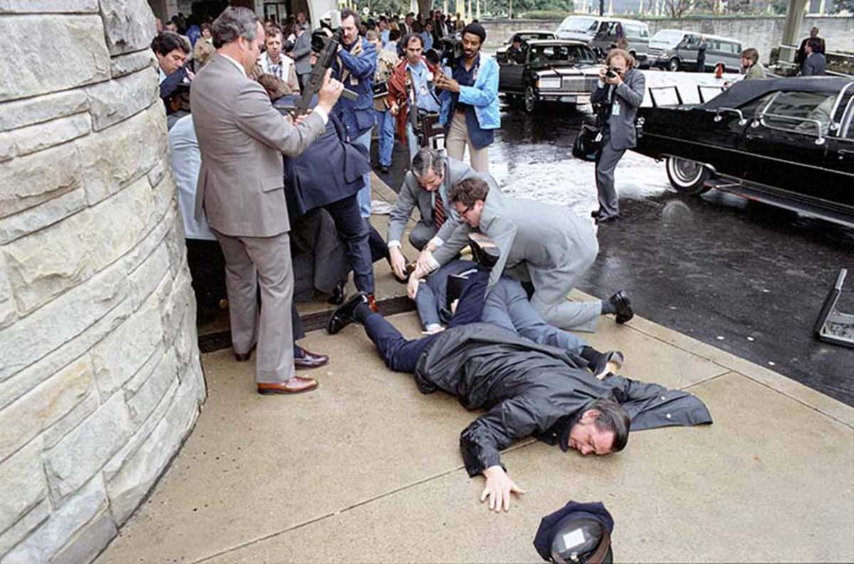President Reagan waves to the crowd immediately before being shot outside the Washington Hilton Hotel