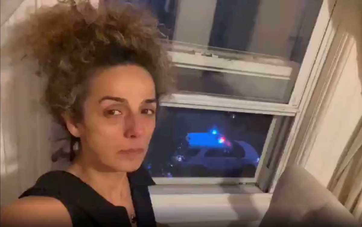 FILE PHOTO: Iranian American journalist Alinejad Masih shows an FBI car guarding outside her apartment
