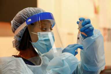 FILE PHOTO: People receive COVID-19 vaccines in Chicago