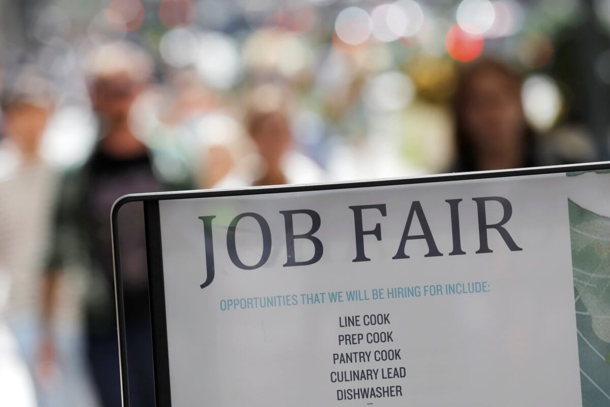 Signage for a job fair is seen on 5th Avenue after the release of the jobs report in Manhattan, New York City