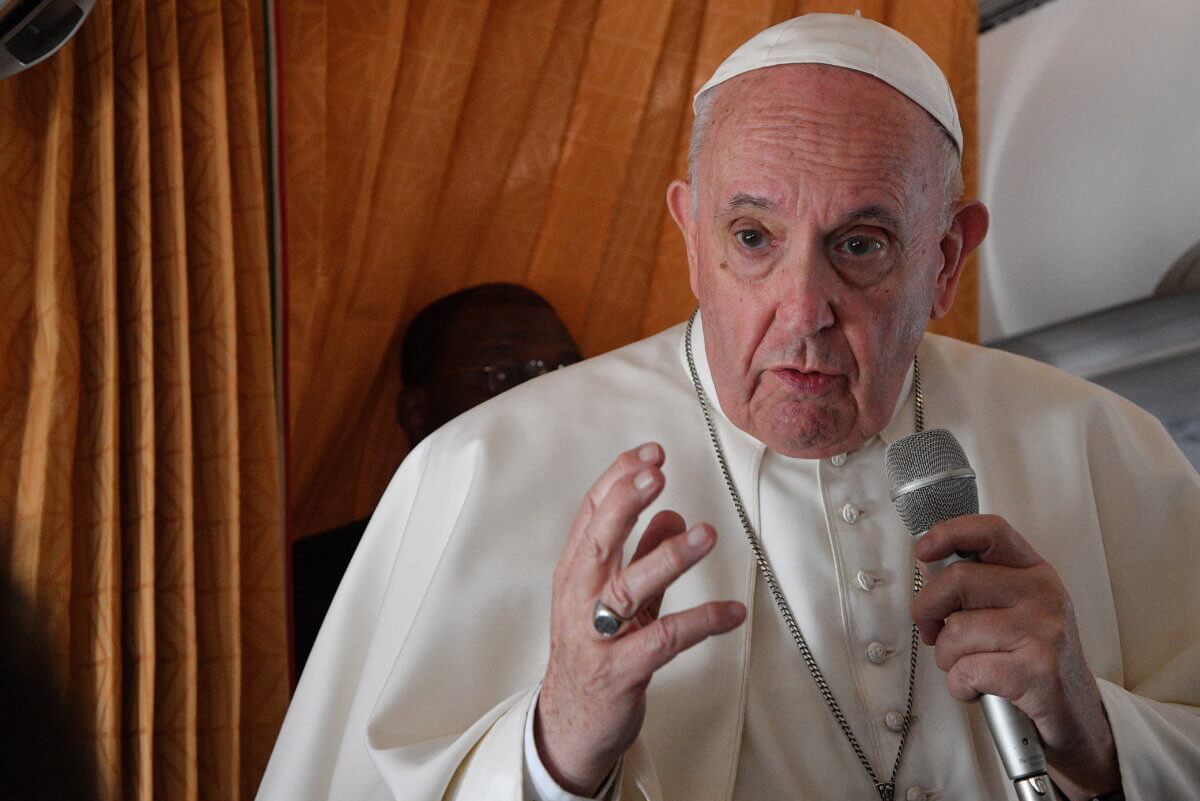 Pope Francis speaks to the media on board an Alitalia aircraft