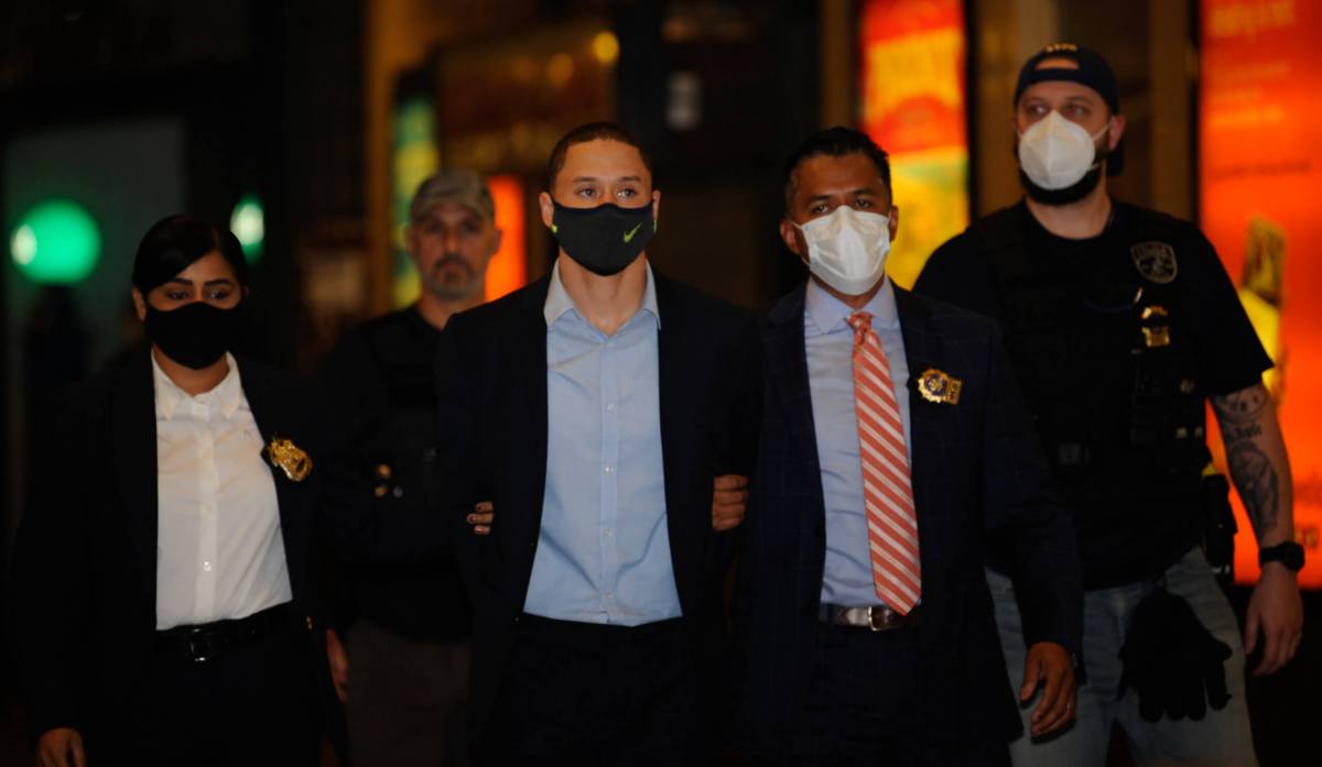 Bradley Hill is walked out of the MTA transit bureau