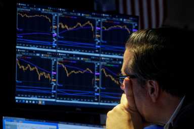 A trader works on the floor of the NYSE in New York