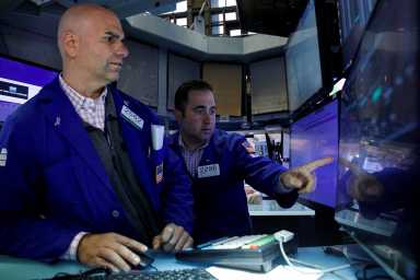 Traders work on the floor of the NYSE in New York