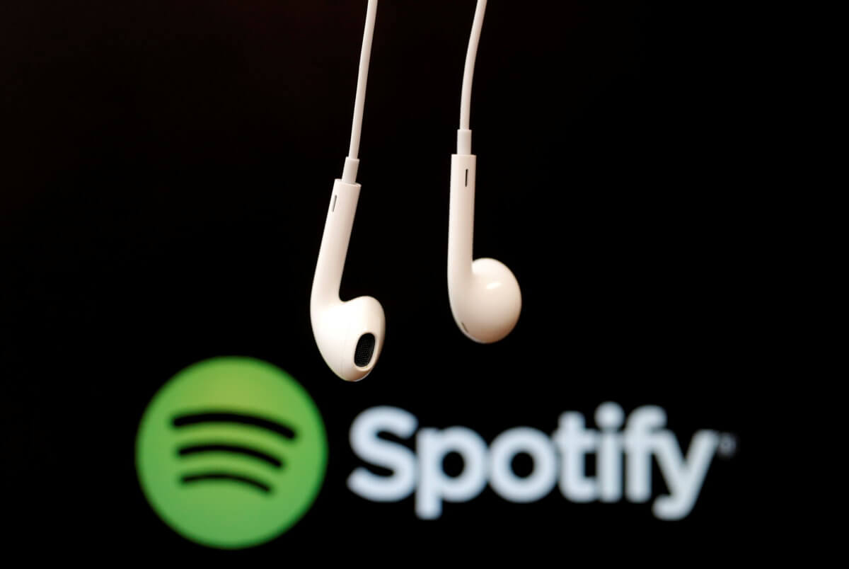 FILE PHOTO: Headphones are seen in front of a logo of online music streaming service Spotify in this illustration picture taken in Strasbourg