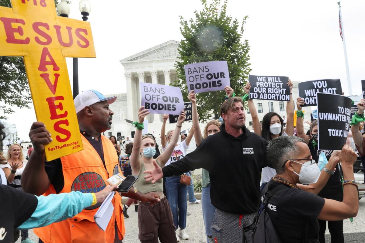 People protest for and against abortion rights outside of the U.S. Supreme Court building in Washington