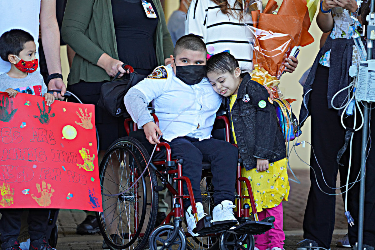 A walkout to remember: Seven-year-old honorary NYPD cop discharged from hospital in Queens to cheers of real officers 9
