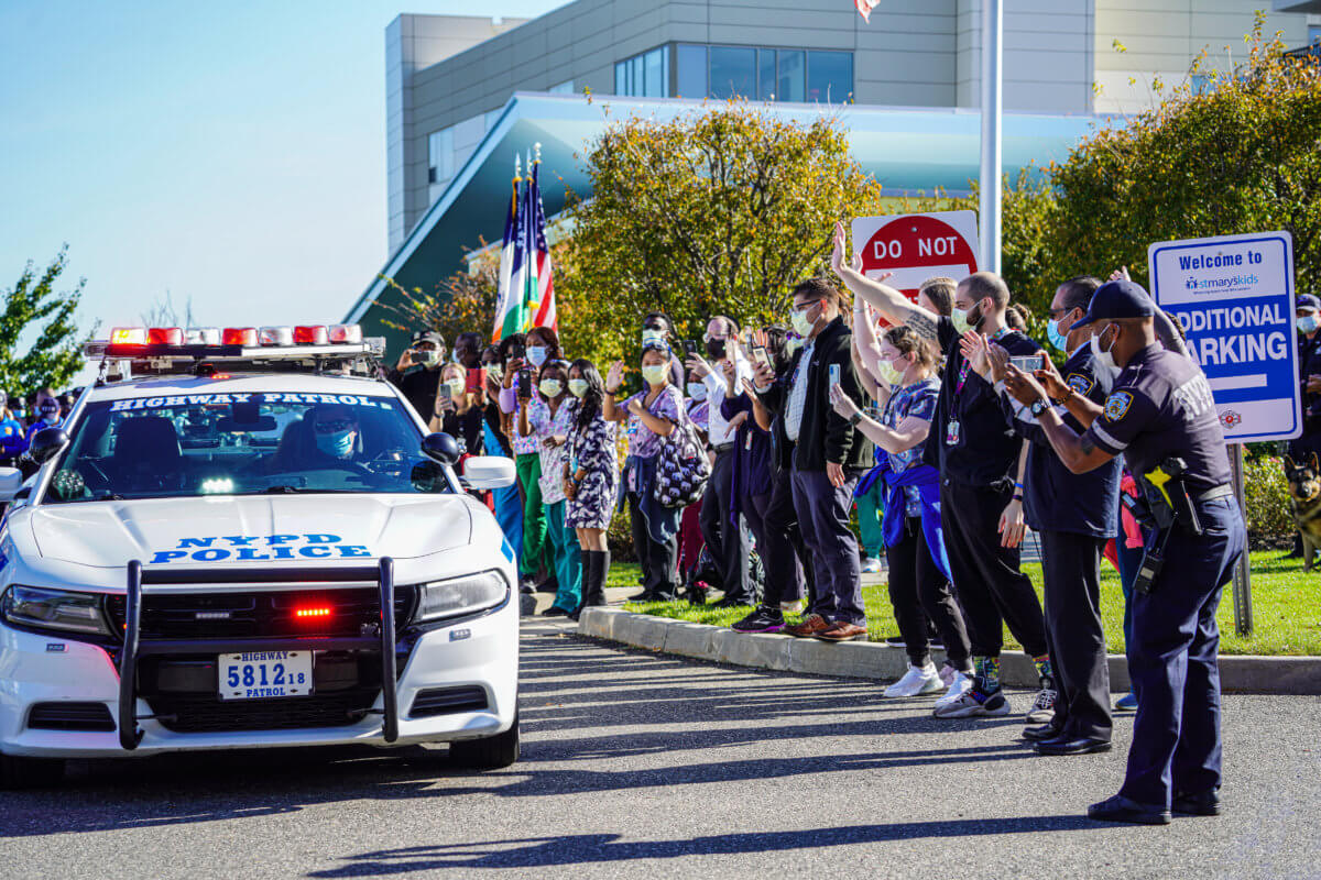 A walkout to remember: Seven-year-old honorary NYPD cop discharged from hospital in Queens to cheers of real officers 13