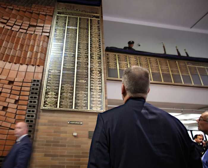 Police commissioner Dermot Shea looks upon the memorial wall.
