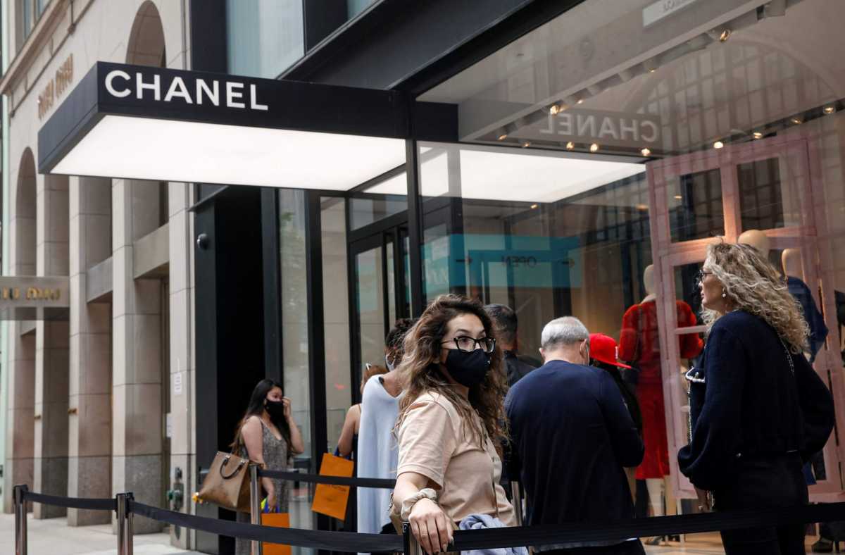 FILE PHOTO: Shoppers wait in line to enter the Chanel store on 57th St in New York