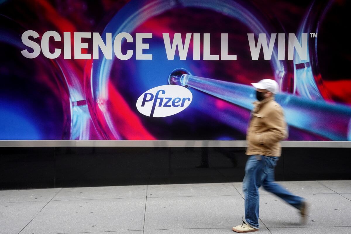 FILE PHOTO: A person walks past the Pfizer Headquarters building in New York City