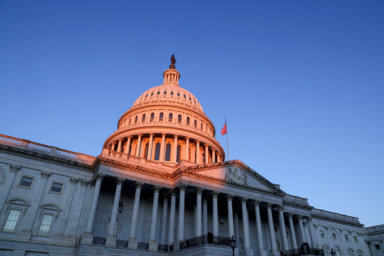 FILE PHOTO: The sun rises on the U.S. Capitol dome before Joe Biden’s presidential inauguration in Washington