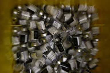 FILE PHOTO: Empty vials of the “Comirnaty” Pfizer-BioNTech COVID-19 vaccine are seen inside a waste package at a coronavirus disease (COVID-19) vaccination center in Madrid