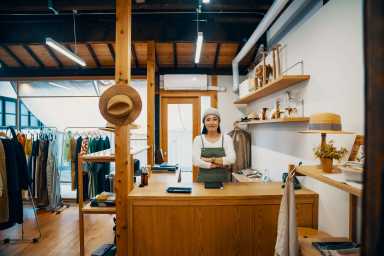 Female small business owner ready to accept mobile payment via digital tablet