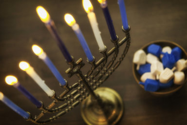 Menorah with burning candles and dreidel. Hanukkah preparations