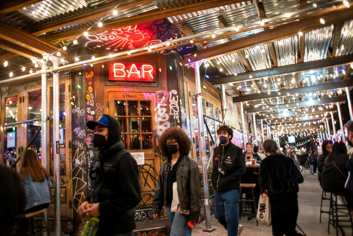 People make their way through local restaurants during the coronavirus pandemic in New York