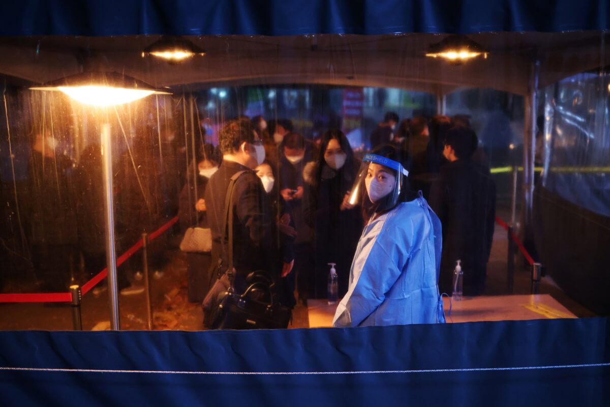 People wait in a line to undergo coronavirus disease (COVID-19) test at its testing site in central Seoul
