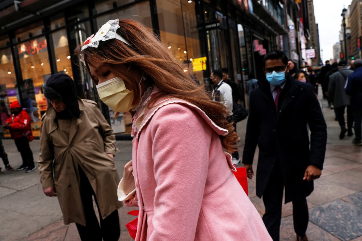 A woman wearing a protective face mask, amid the coronavirus disease (COVID-19) pandemic, walks in New York City