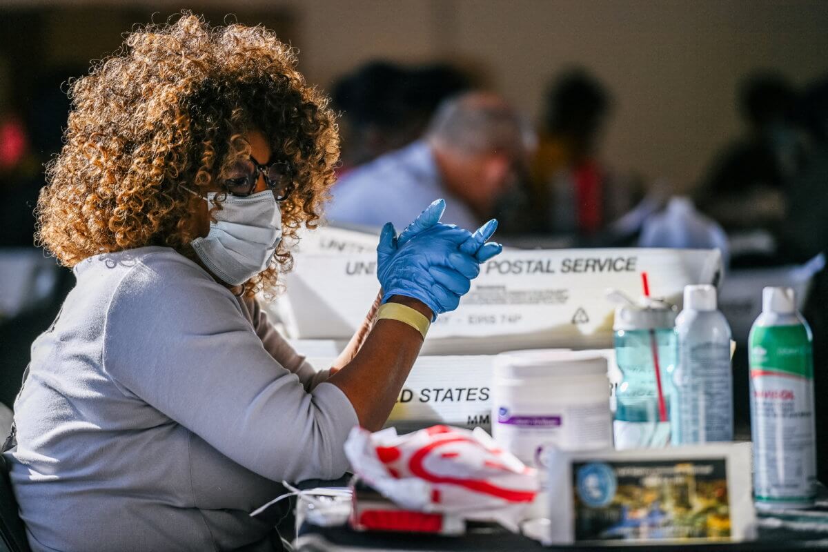 FILE PHOTO: Fulton County election worker Ruby Freeman processes ballots in Atlanta