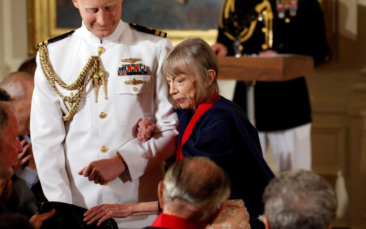 FILE PHOTO: Writer Joan Didion is escorted to her seat after U.S. President Barack Obama awarded her the 2012 National Humanities Medal during a ceremony in Washington