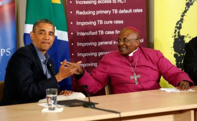 FILE PHOTO: U.S. President Barack Obama is pictured alongside Desmond Tutu as he visits his HIV Foundation Youth Centre and takes part in a health event with youth in Cape Town