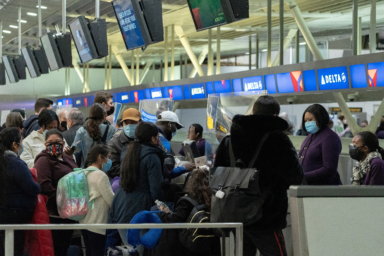 FILE PHOTO: Passengers line up at John F. Kennedy International Airport in New York
