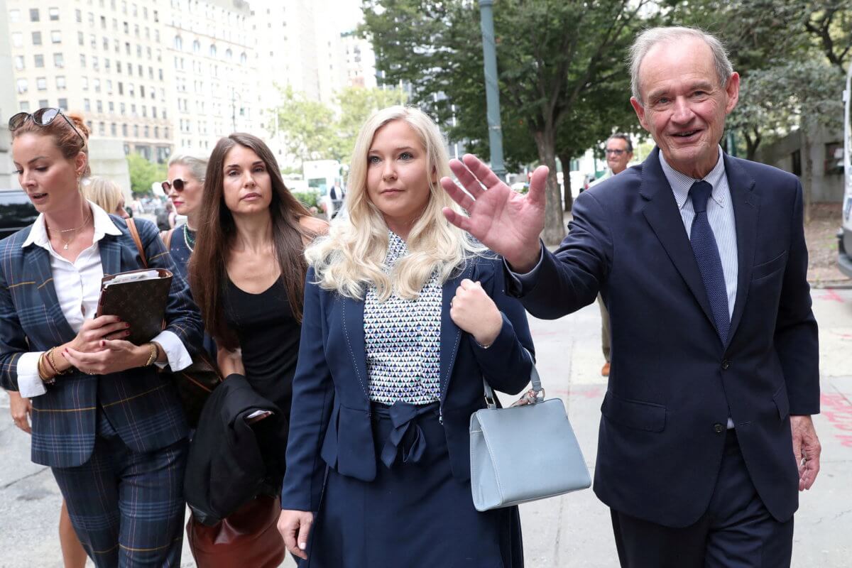 FILE PHOTO: Virginia Giuffre and lawyer David Boies arrive for a hearing in the criminal case against Jeffrey Epstein