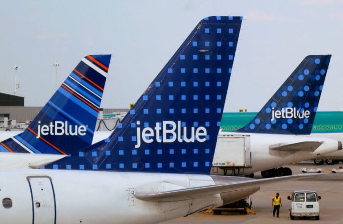 FILE PHOTO: JetBlue Airways aircraft are pictured at departure gates at John F. Kennedy International Airport in New York