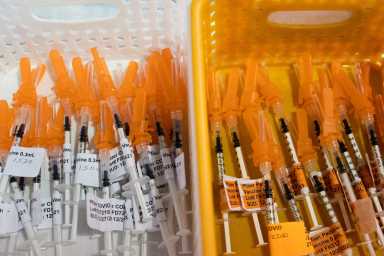 People receive COVID-19 tests and vaccines in Michigan
