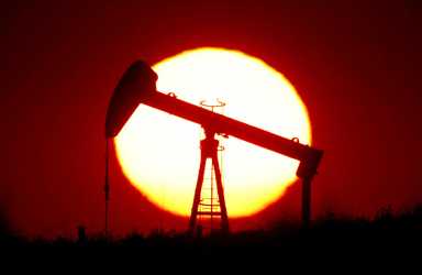 FILE PHOTO: The sun sets behind a pump-jack outside Saint-Fiacre