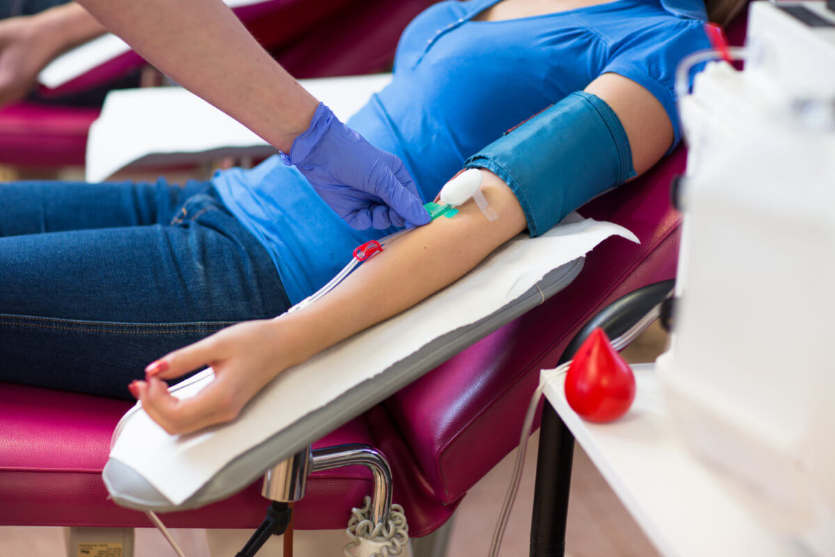 Young woman giving blood in a modern hospital
